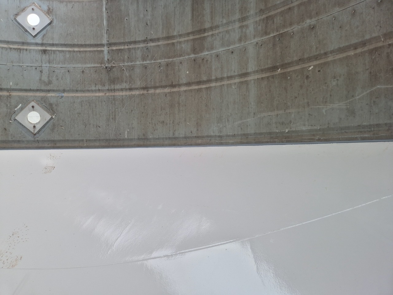 The same silo interior after blasting and coating — clean gloss-finished surface